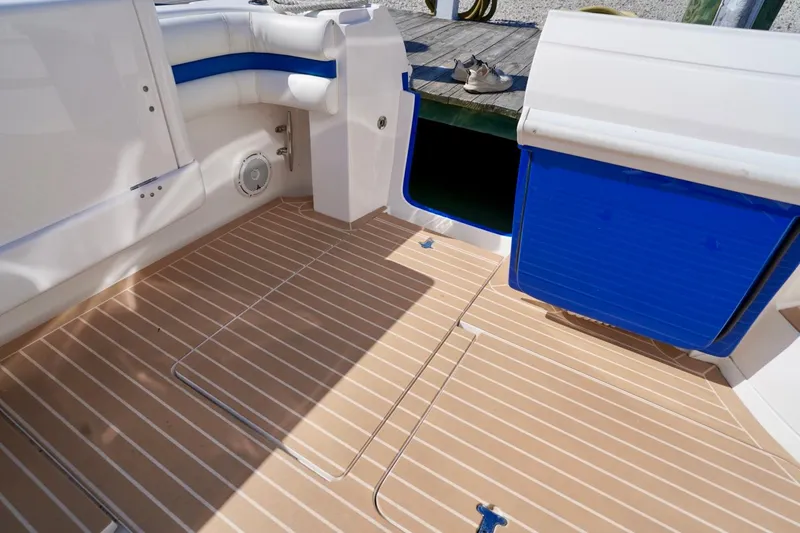 Slide: The Image of 2017 Intrepid 475 Sport Yacht deck with teak flooring and blue accents. - 18