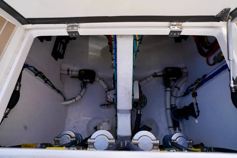 Slide: The Image of Engine compartment of a 2017 Intrepid 475 Sport Yacht, showcasing mechanical components and wiring. - 21