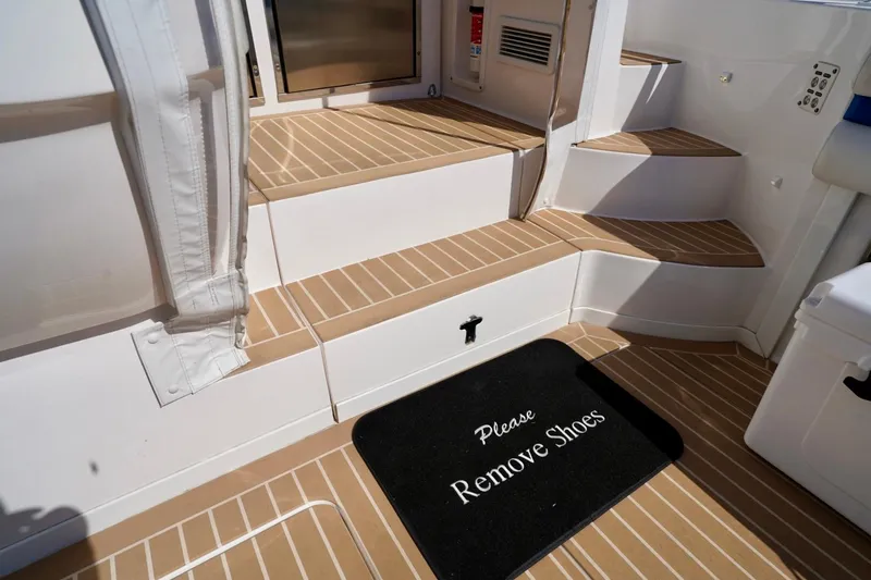 Slide: The Image of Interior steps of a 2017 Intrepid 475 Sport Yacht with "Please Remove Shoes" mat. - 28