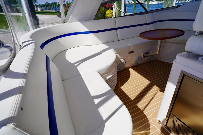 Slide: The Image of Luxurious seating area on a 2017 Intrepid 475 Sport Yacht with elegant wood table. - 32