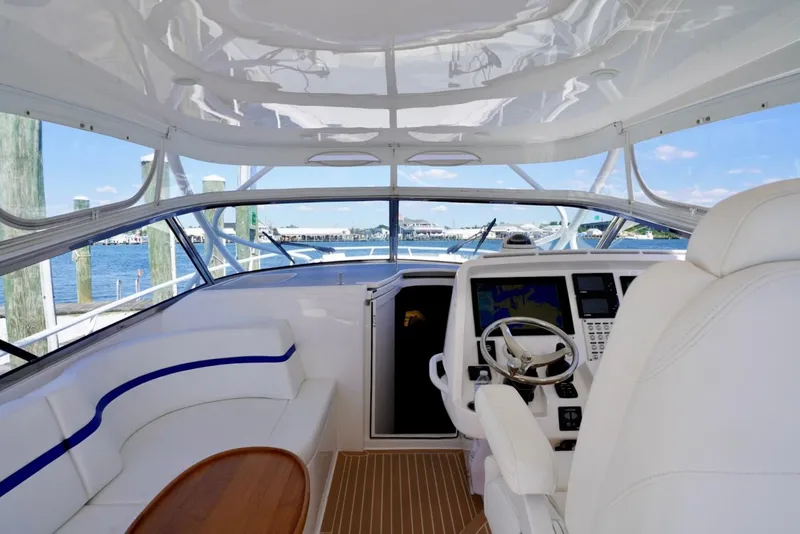 Slide: The Image of Interior view of a 2017 Intrepid 475 Sport Yacht, featuring a sleek helm and seating area. - 34