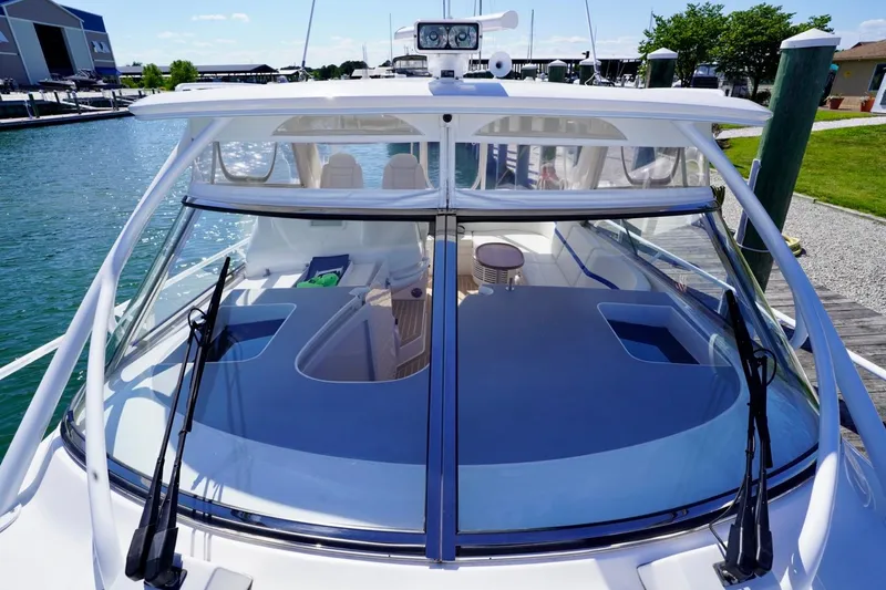 Slide: The Image of 2017 Intrepid 475 Sport Yacht docked, showcasing sleek design and spacious deck. - 35
