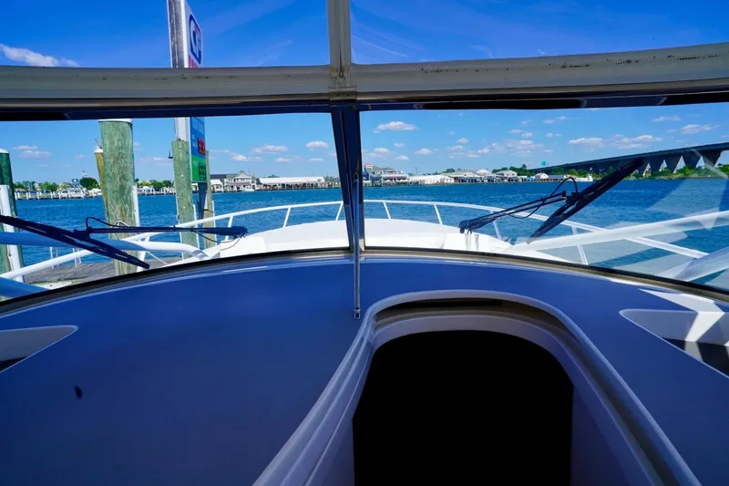 Slide: The Image of 2017 Intrepid 475 Sport Yacht docked with scenic waterfront view. - 38