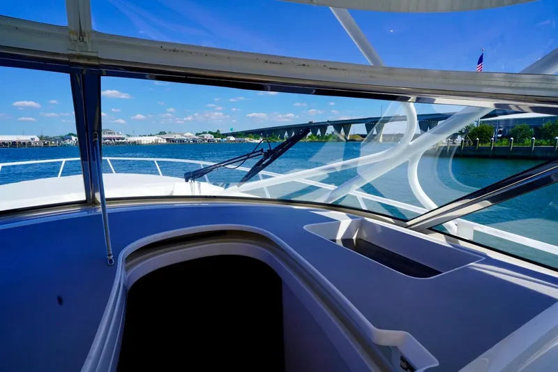 Slide: The Image of 2017 Intrepid 475 Sport Yacht interior view with clear skies and waterfront backdrop. - 39