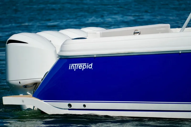 Slide: The Image of 2017 Intrepid 475 Sport Yacht with blue hull and powerful engines on water. - 4