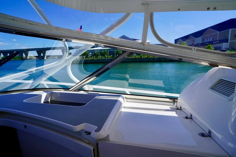 Slide: The Image of Interior view of 2017 Intrepid 475 Sport Yacht with waterfront and bridge in background. - 40