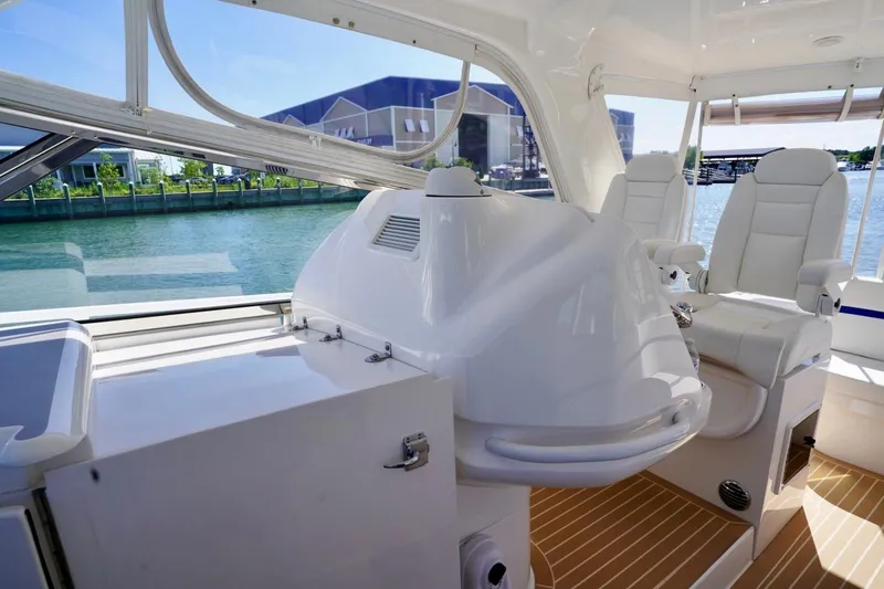 Slide: The Image of Interior of 2017 Intrepid 475 Sport Yacht with white seating and waterfront view. - 41