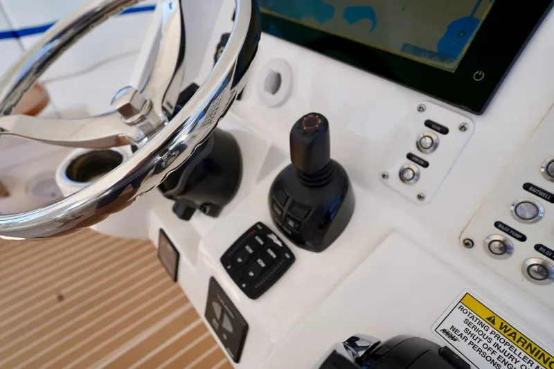 Slide: The Image of Control panel of a 2017 Intrepid 475 Sport Yacht with steering wheel and navigation controls. - 43