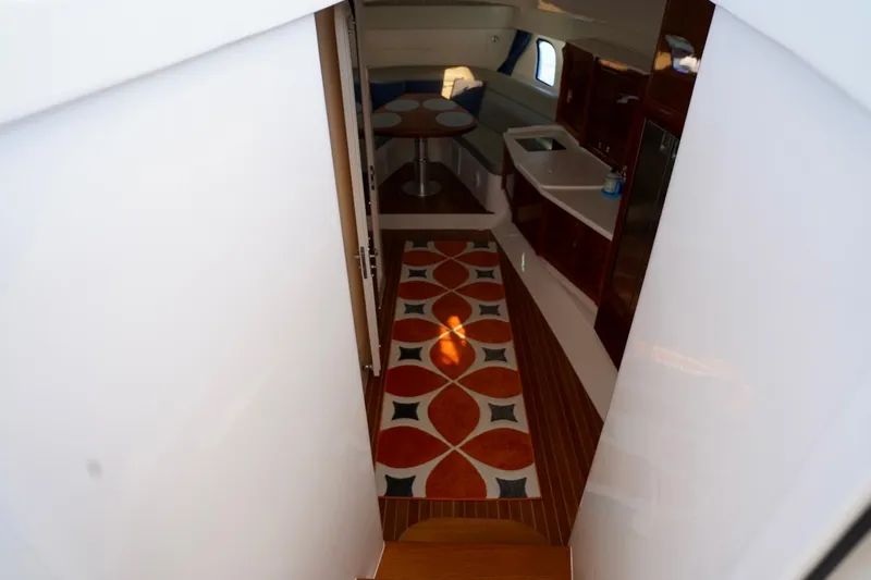 Slide: The Image of Interior view of 2017 Intrepid 475 Sport Yacht with modern kitchen and patterned rug. - 44