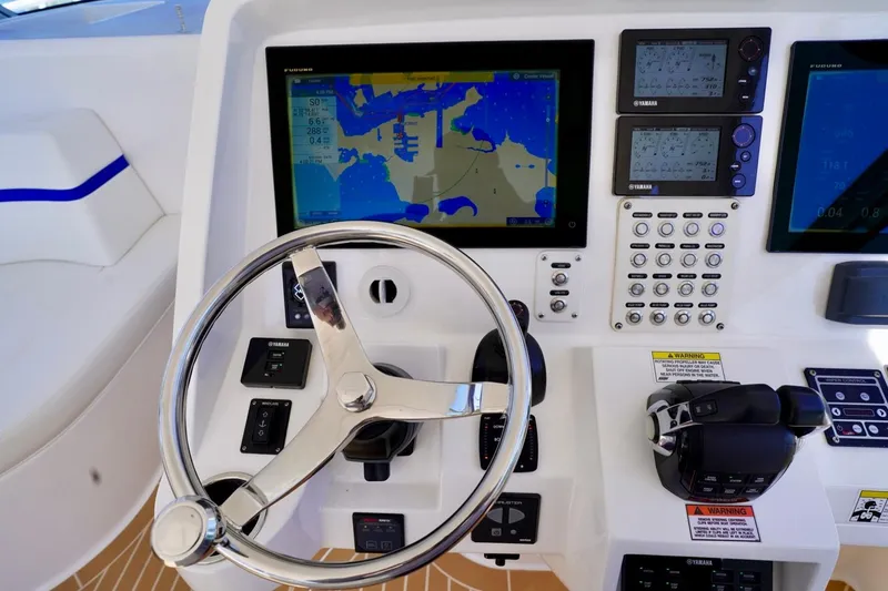 Slide: The Image of Control panel of a 2017 Intrepid 475 Sport Yacht with navigation screens and steering wheel. - 46