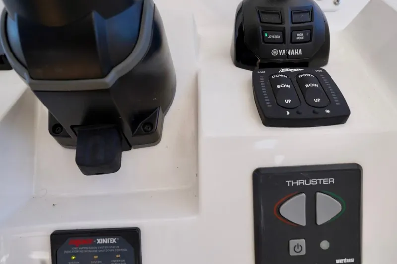 Slide: The Image of Control panel of a 2017 Intrepid 475 Sport Yacht featuring Yamaha joystick and thruster controls. - 49
