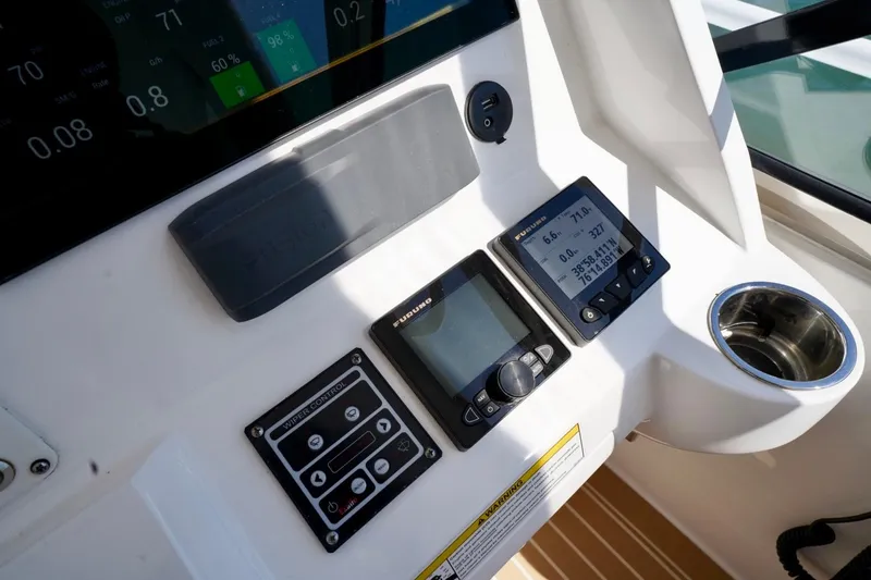 Slide: The Image of Control panel of a 2017 Intrepid 475 Sport Yacht with navigation displays and cup holder. - 50