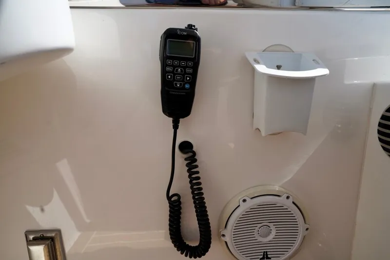 Slide: The Image of VHF radio and speaker on 2017 Intrepid 475 Sport Yacht dashboard. - 51