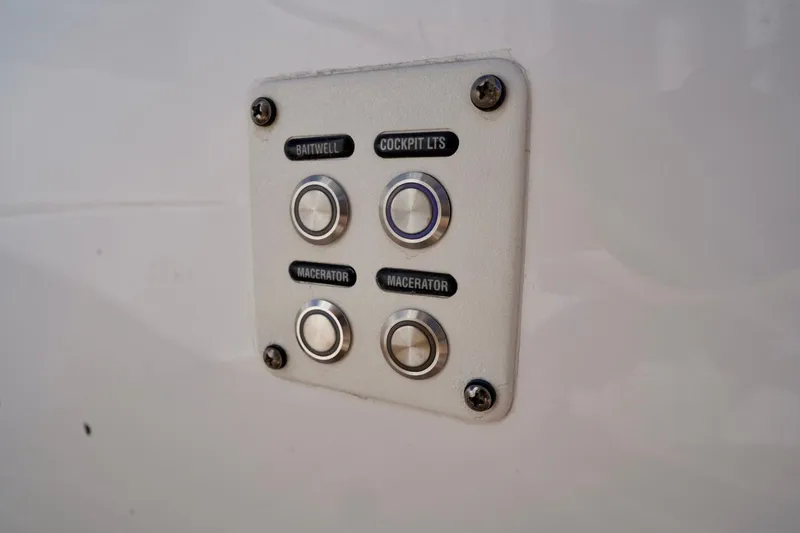 Slide: The Image of Control panel on a 2017 Intrepid 475 Sport Yacht with labeled buttons. - 54