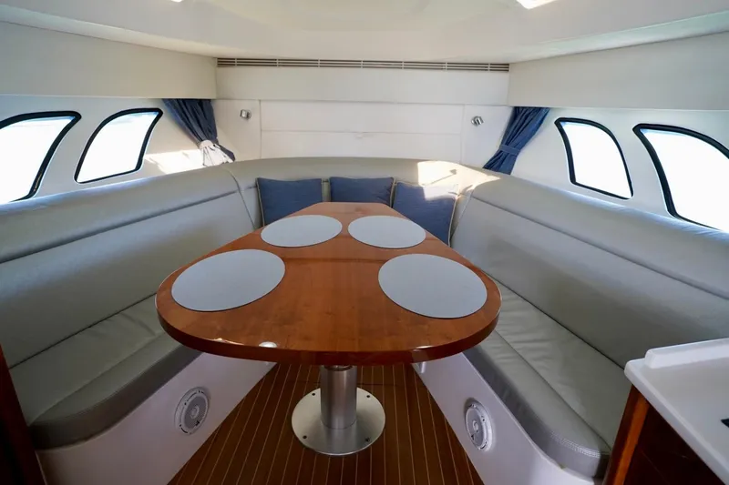 Slide: The Image of Luxurious interior of 2017 Intrepid 475 Sport Yacht with elegant seating and wooden table. - 59