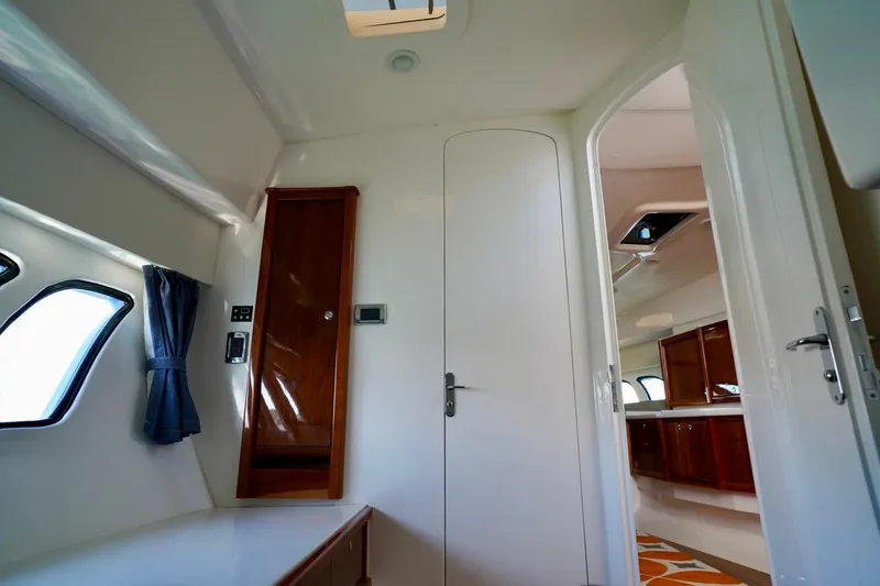 Slide: The Image of Interior of 2017 Intrepid 475 Sport Yacht, featuring sleek design and wooden cabinetry. - 65