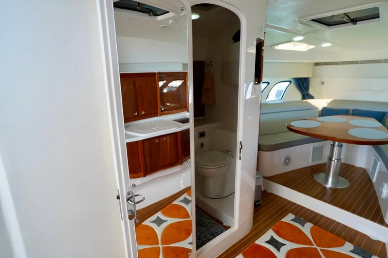 Slide: The Image of Interior of 2017 Intrepid 475 Sport Yacht featuring bathroom and dining area with modern decor. - 66