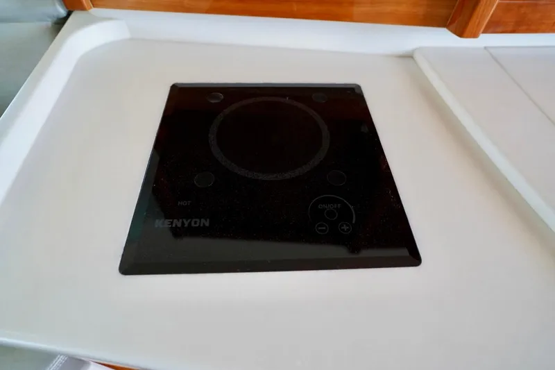 Slide: The Image of Kenyon cooktop on 2017 Intrepid 475 Sport Yacht kitchen counter. - 68