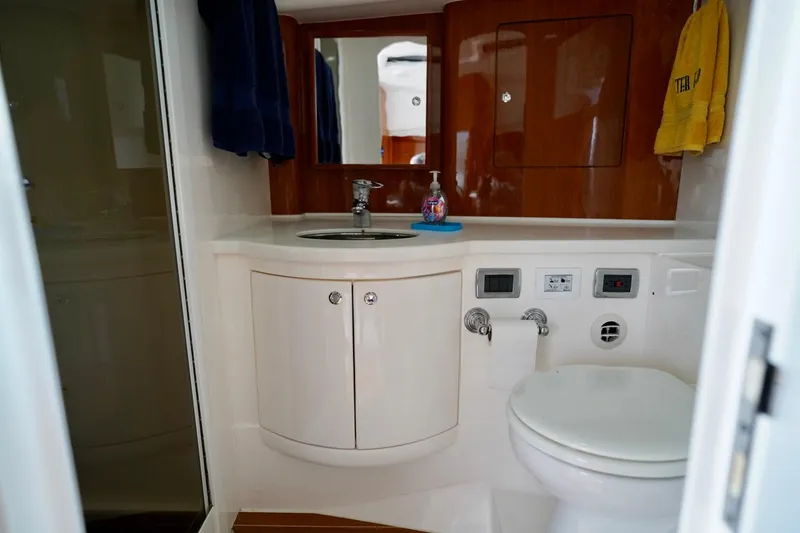 Slide: The Image of Luxurious bathroom in 2017 Intrepid 475 Sport Yacht with modern fixtures and wooden accents. - 70