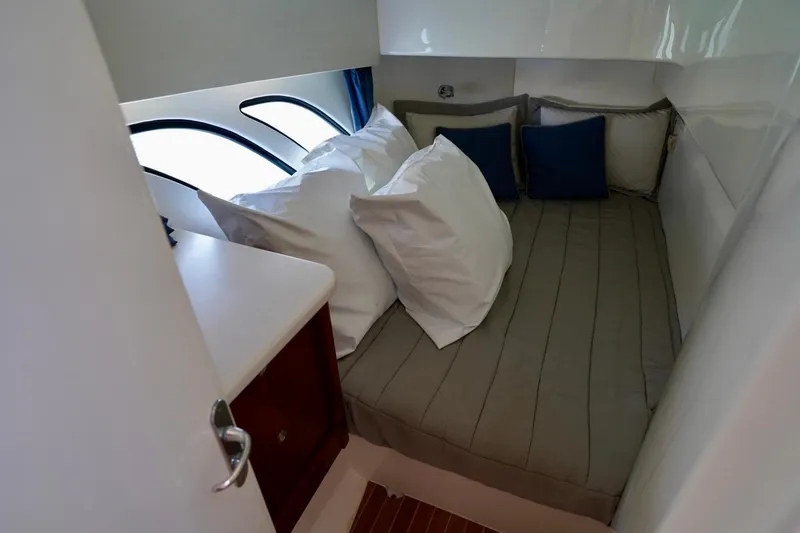 Slide: The Image of Cozy cabin interior of 2017 Intrepid 475 Sport Yacht with plush bedding and modern design. - 72