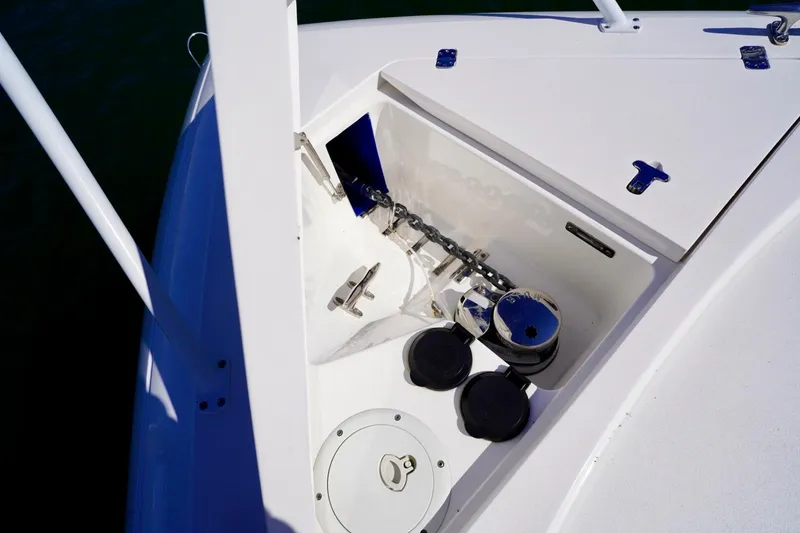 Slide: The Image of Anchor compartment of 2017 Intrepid 475 Sport Yacht, featuring chain and winch system. - 73