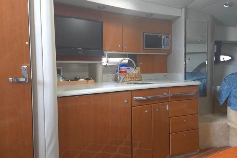 Slide: The Image of 2005 Formula 37 Performance Cruiser interior with kitchenette, TV, and microwave. - 13