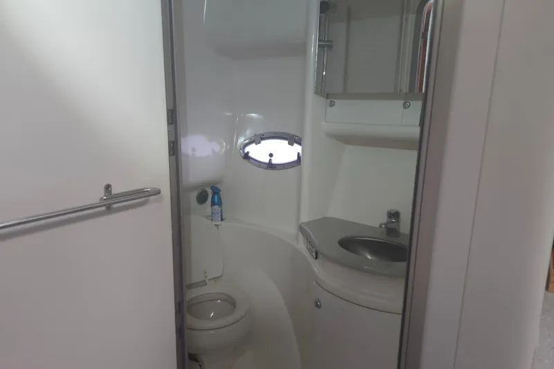 Slide: The Image of 2005 Formula 37 Performance Cruiser bathroom with toilet, sink, and porthole window. - 20