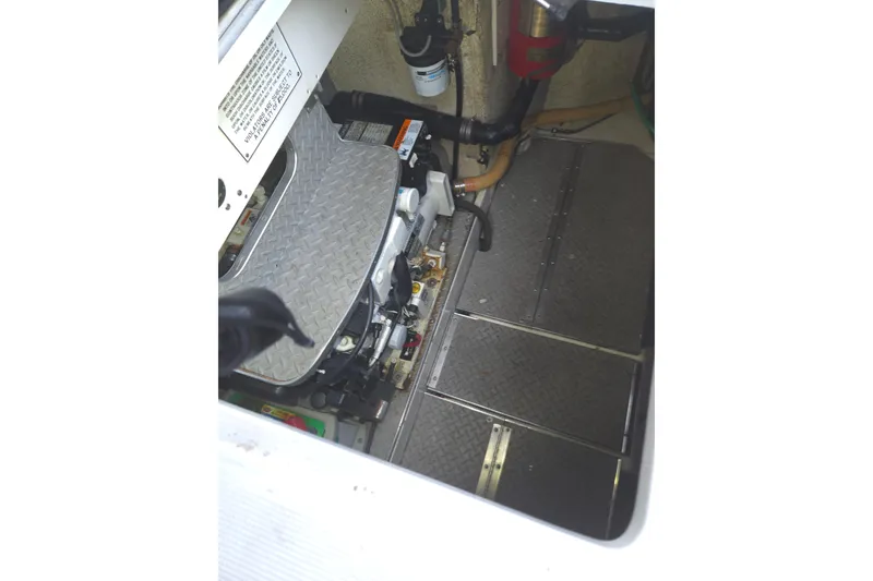 Slide: The Image of Engine compartment of a 2005 Formula 37 Performance Cruiser, showing mechanical components and piping. - 21