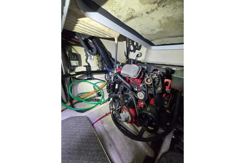 Slide: The Image of Engine compartment of a 2005 Formula 37 Performance Cruiser, showcasing mechanical components and wiring. - 23