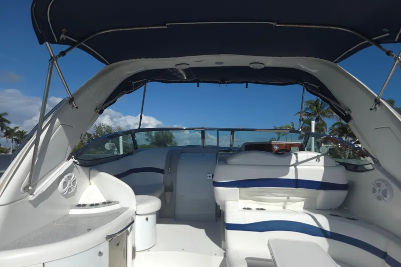 Slide: The Image of 2005 Formula 37 Performance Cruiser interior with seating and canopy under clear blue sky. - 25