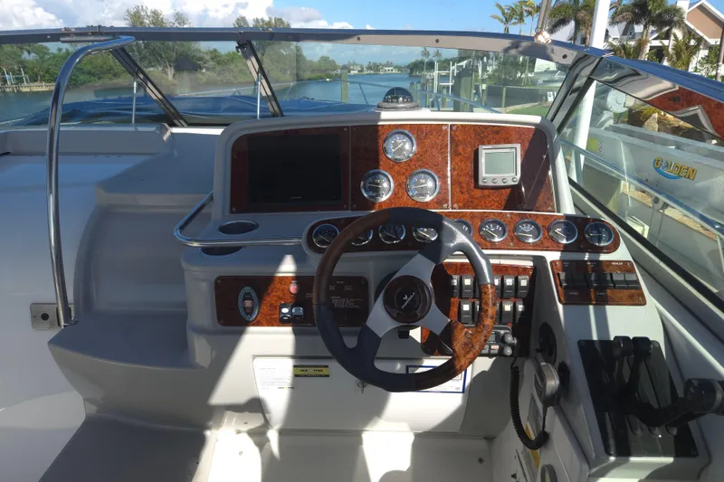 Slide: The Image of Cockpit of 2005 Formula 37 Performance Cruiser with wood accents and modern controls. - 27