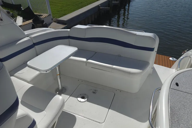 Slide: The Image of 2005 Formula 37 Performance Cruiser interior with white seating and table by the water. - 28