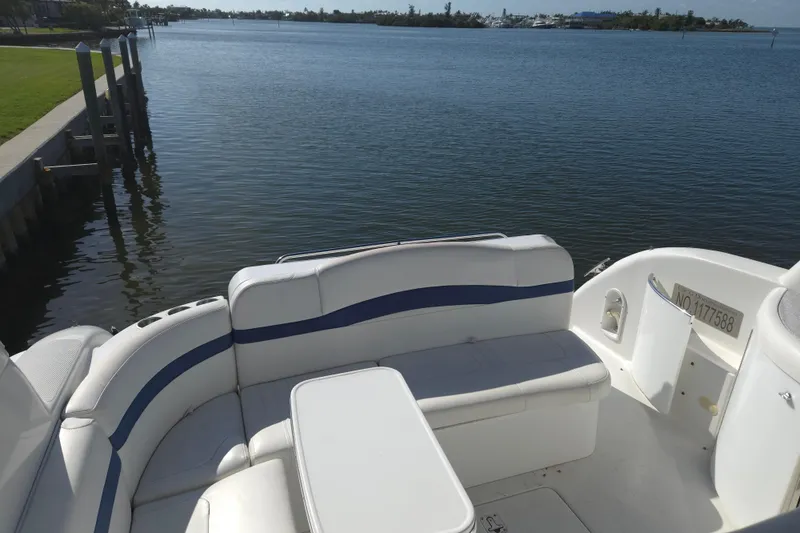 Slide: The Image of 2005 Formula 37 Performance Cruiser with white seating, docked by a serene waterfront. - 30