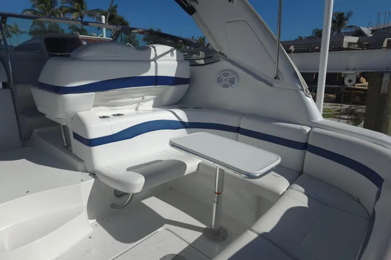 Slide: The Image of 2005 Formula 37 Performance Cruiser interior with white seating and table, docked under blue sky. - 31