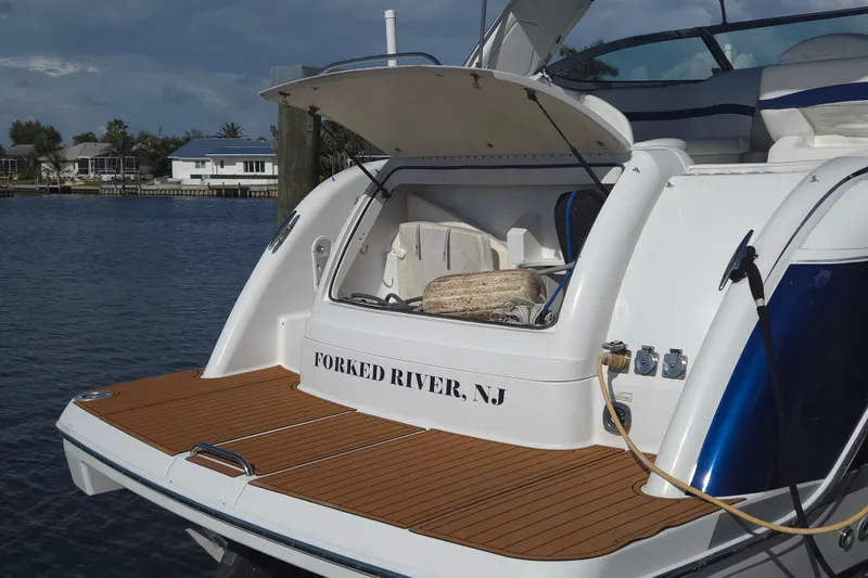 Slide: The Image of 2005 Formula 37 Performance Cruiser docked in Forked River, NJ, with open storage compartment. - 32