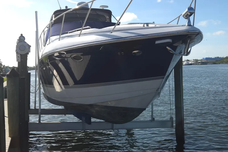 Slide: The Image of 2005 Formula 37 Performance Cruiser on lift by waterfront dock. - 35