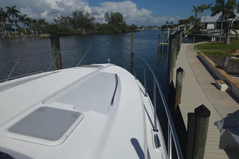 Slide: The Image of 2005 Formula 37 Performance Cruiser docked by a scenic waterfront with palm trees. - 9