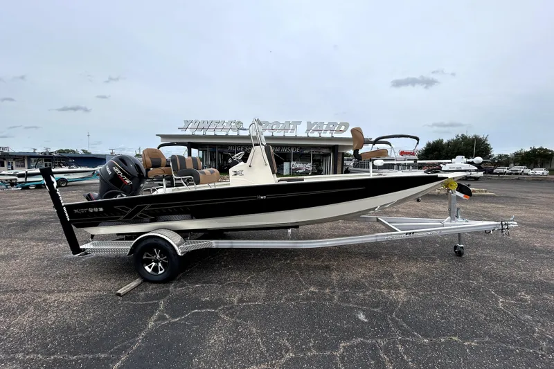 The Image of 2026 Xpress H20B Bay boat on trailer at dealership, showcasing sleek design and modern features. - 0