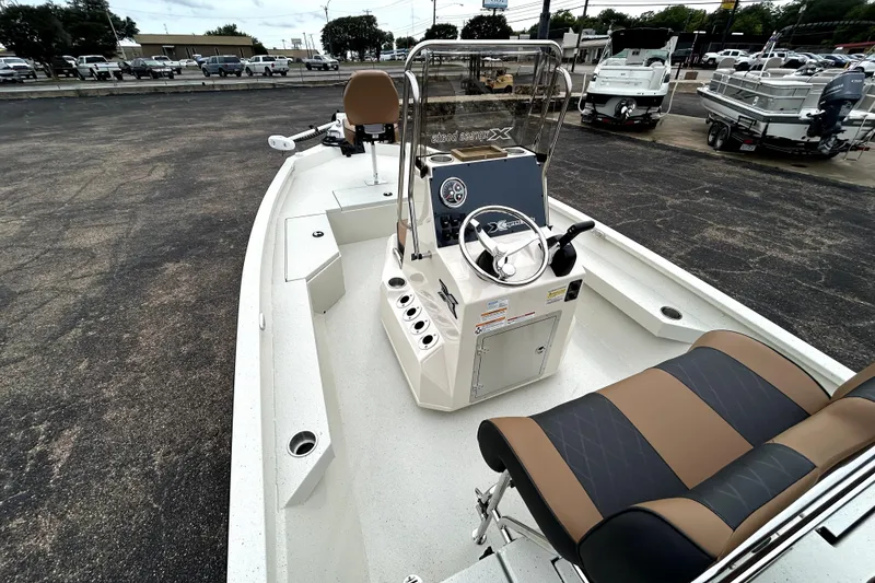 Slide: The Image of 2026 Xpress H20B Bay boat interior with steering console and seating. - 11