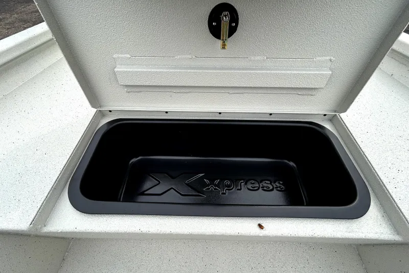 Slide: The Image of Open storage compartment in 2026 Xpress H20B Bay boat. - 19