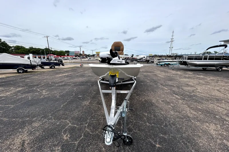 Slide: The Image of 2026 Xpress H20B Bay boat on trailer in outdoor dealership lot. - 2