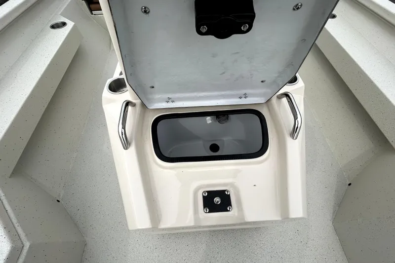 Slide: The Image of 2026 Xpress H20B Bay boat interior with open storage compartment and cup holders. - 25