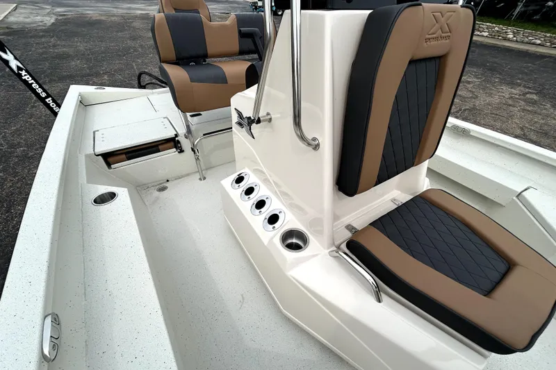Slide: The Image of 2026 Xpress H20B Bay boat interior with cushioned seating and console details. - 28
