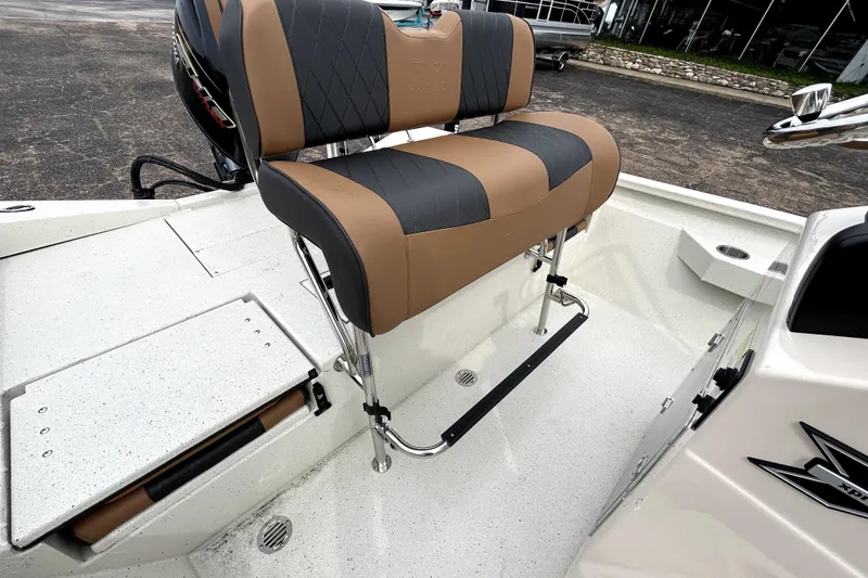 Slide: The Image of 2026 Xpress H20B Bay boat interior with cushioned seating and storage compartment. - 33