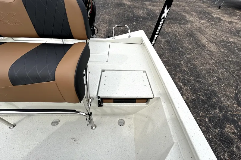 Slide: The Image of 2026 Xpress H20B Bay boat interior with cushioned seating and storage compartment. - 34