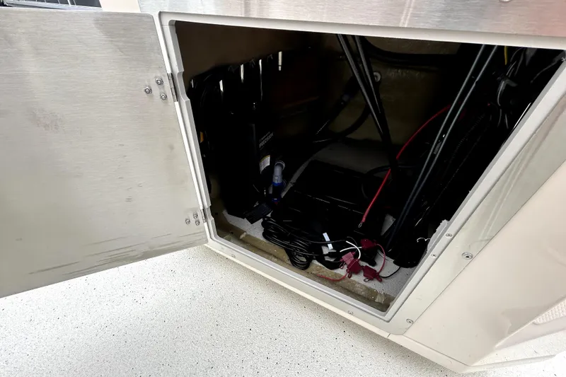 Slide: The Image of Open compartment of 2026 Xpress H20B Bay boat showing internal wiring and components. - 39