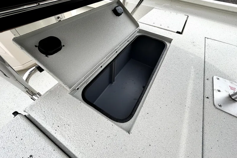 Slide: The Image of Open storage compartment on 2026 Xpress H20B Bay boat deck. - 41