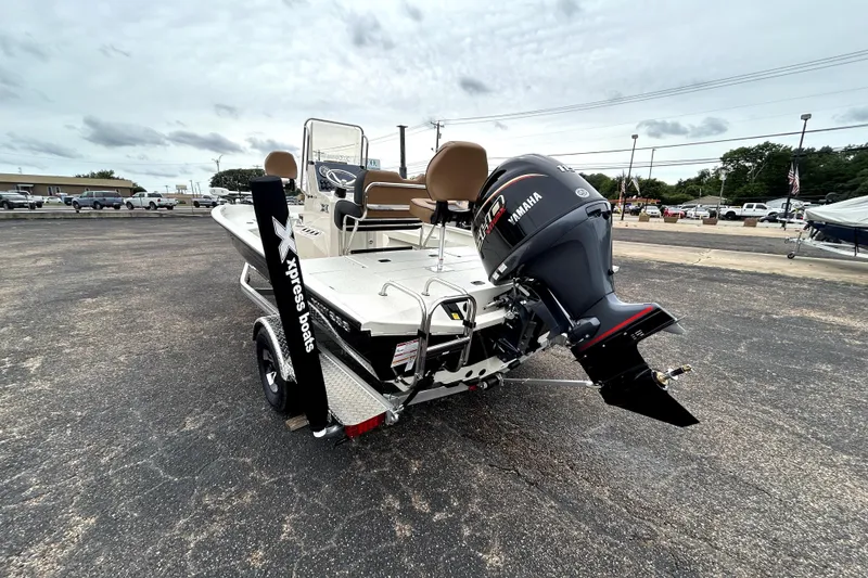 Slide: The Image of 2026 Xpress H20B Bay boat with Yamaha engine in a parking lot. - 5