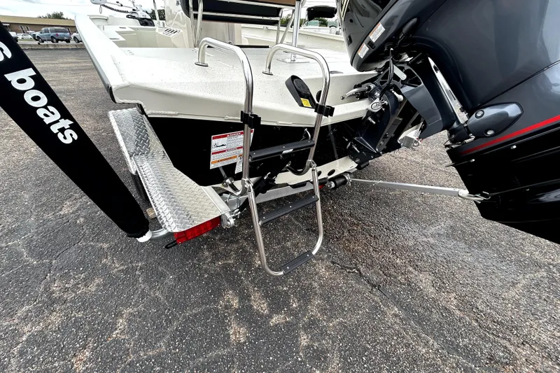 Slide: The Image of Rear view of 2026 Xpress H20B Bay boat with motor and ladder. - 7