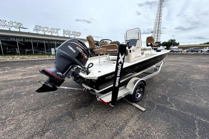 Slide: The Image of 2026 Xpress H20B Bay boat with Yamaha engine on trailer at dealership. - 9